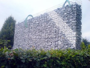 Bau eines Wasserfalls - Die Leitungen des Wasserfalls laufen durch die Gabionen, unsichtbar auf Vorder- und Rückseite -
